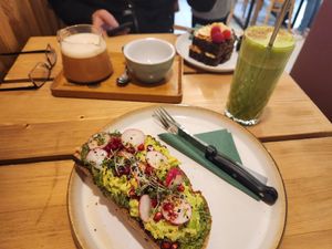 Avotoast and autumn matcha latte (with PB&J on banana bread in the background) at Coffee Room in Prague