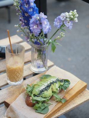 Avocado toast with vegan pesto and iced latte with oat milk at Coffee Room in Prague
