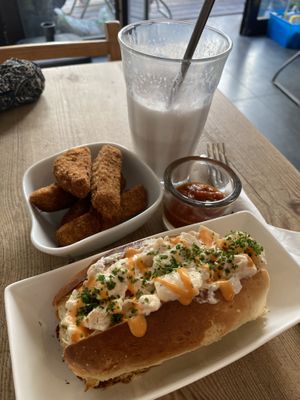 Seitan wings with dipping sauce, lobster roll, cherry milkshake partially drunk  at The Judgy Vegan in Brussels