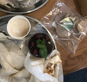 Tofu wrap, americano with almond milk and cherry- chocolate cake at MOMO in Kyiv