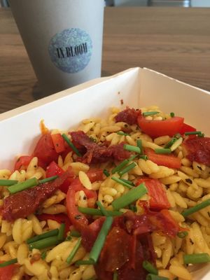 Rainbow orzo pasta box with soy flat white. Perfect  at In Bloom in Glasgow