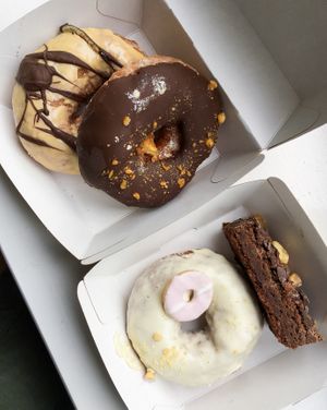 (from top left to bottom right) salted caramel and chocolate doughnut,, chocolate honeycomb doughnut,, vanilla party ring doughnut,, chocolate brownie at In Bloom in Glasgow