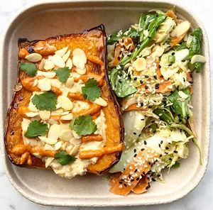 Butternut squash filled with hummus and harissa dressing, served with our best selling pal Choi and carrot salad at Detox Kitchen and Juice Bar in Belmont