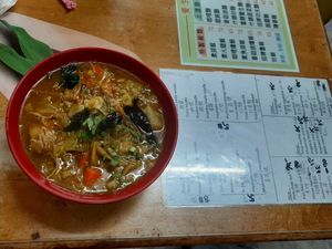 Curry noodles and menu on the table at Jiu Liu Su Shi in Taichung