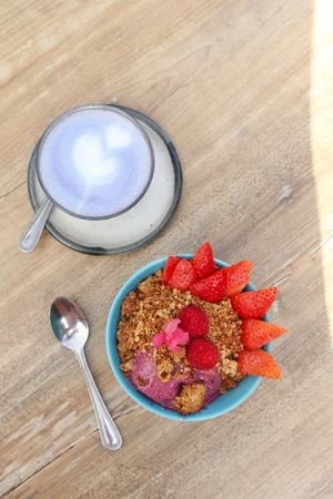 Dragonfruit smoothie bowl with granola & berries + butterfly latte  at Farm Girl Cafe in West London