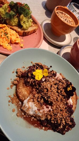 Vegan pancakes with roasted pear compote, coconut yoghurt, granola and marple syrup at Farm Girl Cafe in West London