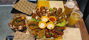 Poutine Tater Tots + CHKN Wings Platter: Buffalo Hot, Lemon Pepper, Garlic Parmesan & Nashville BBQ. Easy Livin' beer (top) & Hazey Daze beer (bottom). at Got No Beef in Cardiff
