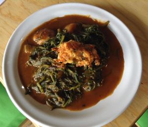 romeritos en mole rojo con croqueta de zanahoria y papas  at El Mana Vegetarian in Mexico City