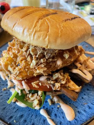 Hash brown stack in brioche burger   at No 18 Cafe in Swansea