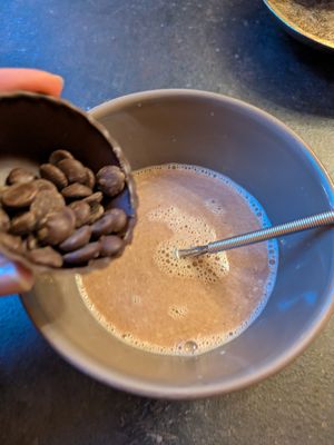 Whisking in the chocolate at The Old Chocolate House in Bruges