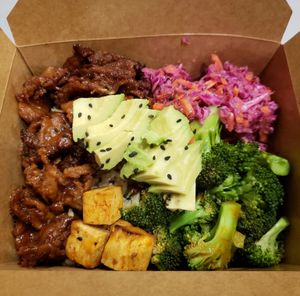 General Copper bowl, made with General Tao Shiitake mushroom, broccoli, avocado, brown rice, sesame seeds, sriracha coleslaw, and smoked tofu. at Copper Branch in Toronto