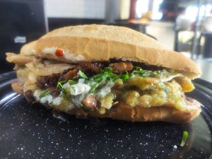 Torta de chilaquiles with extra Bistek meat at Por Siempre Vegana Vol II in Mexico City