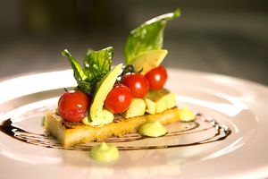 Confit cherry tomatoes on rosemary and roast garlic bruschetta with avocado and balsamic dressing at Breda Murphy Restaurant in Whalley