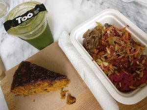 Detox homemade juice, beet hummus with bgur and vegetables, carrot cake with chocolate topping. All vegan at TOO Naturally Healthy Food in Lisbon