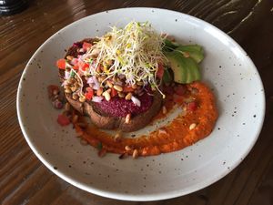 Beetroot Hummus on dark rye with brown lentil salad, harissa, toasted pine nuts and avocado instead of haloumi at The Silly Goat in Broken Hill