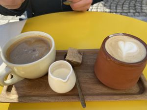America with regular milk + cappuccino with coconut milk 💚 at Vero Caffe in Bruges