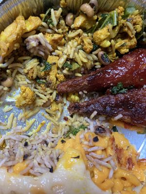 My delicious half-eaten vegan plate: BBQ drumsticks, mac-and-cheese, rice, black eyed peas, cauliflower at Veggie Castle in Jamaica