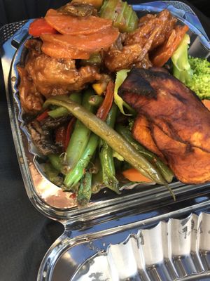Two sides one protein - string bean mushrooms , steam broccoli , vegan ginger chicken   at Veggie Castle in Jamaica