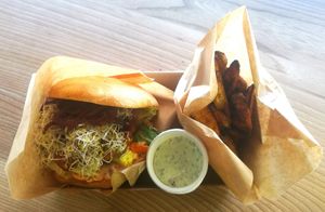 Vegan (from Swedish tempeh "Bärta") luxury burger with homemade condiments served in irganic bread with a side of spicy roasted potatoewedges and a dip. at PAUSA MAT O GELATO in Simrishamn