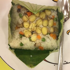 Steamed rice with lotus seeds and vegetables wrapped in lotus leaf at Loving Hut - Hoa Dang in Ho Chi Minh City