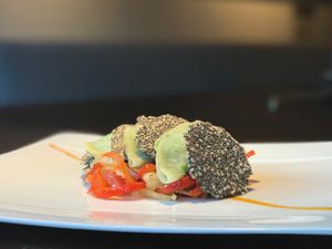 Celeriac Ravioli filled with peas on peppers and onion, chia and linen seeds bread at Posta Zirm Hotel in Corvara In Badia