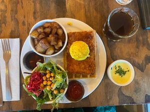 The schnitzel waffle benechick with hollandaise sauce on the side and a turkish coffee  at Chickpea Restaurant in Vancouver