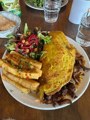 Breakfast Platter: Chickpea’s original Vegan Omelette with cheese, side salad, plus chickpea fries (for a little extra) at Chickpea Restaurant in Vancouver