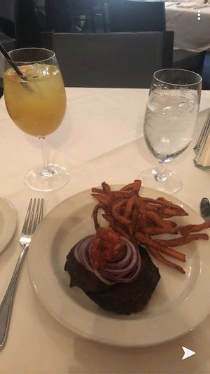 Portabella mushroom burger no bun and AMAZING sweet potato fries with a white sangria  at Magnolias in Charleston