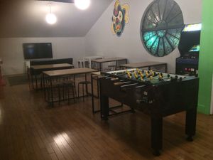 Upstairs eating area with coin games at The Playhouse & Swillburger in Rochester