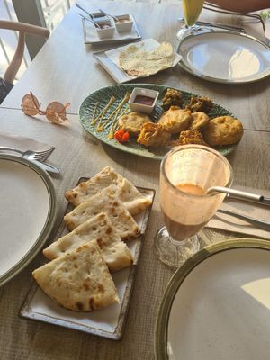 Cheese naan, mixed starters plate, papadam and some sauces at Spice Garden in Sitges
