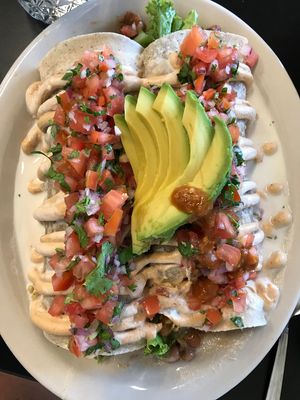 Double Burrito (rice and bean) topped with crema sauce and sprinkled with pico.   at Herbivoro in Portland