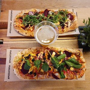 Two own-compositions with vegan bacon and a different selection of cheese and veggies at Pizzatopia in Krakow