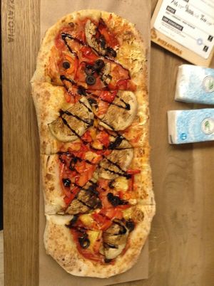 pizza with vegan cheese and veggies at Pizzatopia in Krakow