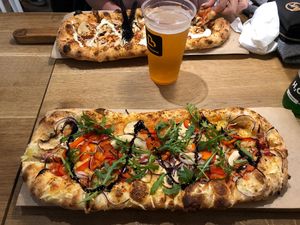 Best vegan pizza!! (The pizza in the background is not vegan) at Pizzatopia in Krakow