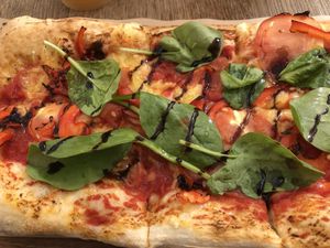 Vegan pizza, vegan mozzarella, tomatoes, spinach, peppers & balsamic truffle sauce!  at Pizzatopia in Krakow