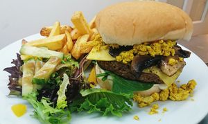Brunch burger topped with tofu scramble and fried mushrooms at Potato Tomato - The Eatery in Whitstable