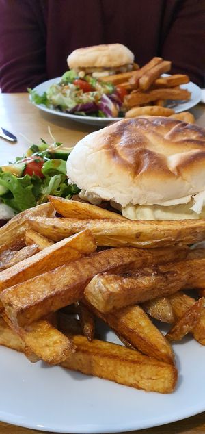 Burgers with macaroni cheese and stan bacon and those amazing chips! at Potato Tomato - The Eatery in Whitstable