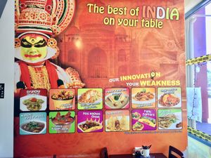 Mural on the wall with lots of food pics  at Go Chaatzz in Fremont