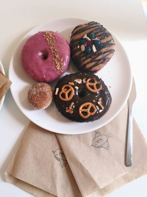 Chai and walnut, chocolate and berries, chocolate pretzel and a cinnamon ball at Donut Shop in Prague