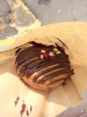 Delicious blueberry chocolate donut filled with jam. at Donut Shop in Prague
