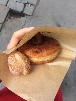 Avocado, banana and chocolate donut with small ball.  at Donut Shop in Prague