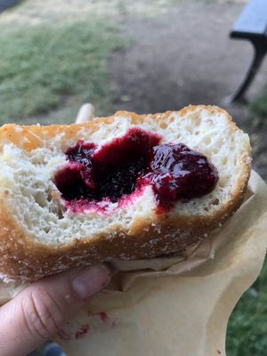 Inside view of black and white currant filled vegan donut at Donut Shop in Prague
