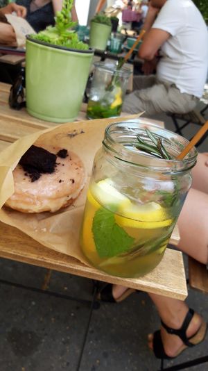 Lemon-brownie donut plus homemade ice tea at Donut Shop in Prague