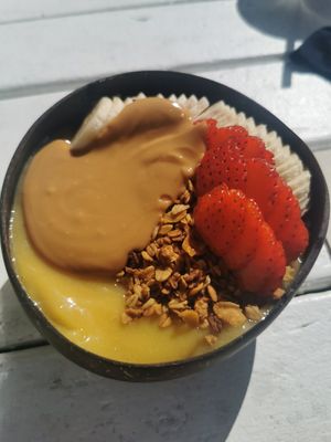 Mango smoothie bowl with almond butter at Nalu Bowls in Ericeira