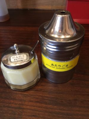 Garlic and sesame seeds placed at each seat. at Kyushu Jangara Ramen - Harajuku in Tokyo