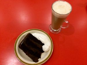 A slice of vegan choc fudge cake with whipped cream and soya latte. at Beach House Cafe in Great Yarmouth