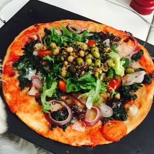 Superfood salad in the middle of my 600 calories pizza with vegan cheese! at Pizza Express in South East London