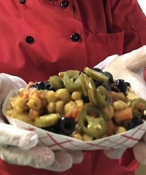 Being handed my scrumptious Vegan Nachos. These are absolutely amazing, I love mine served up all the with "The Secret Sauce" at EBN's Vegan Cuisine in Charlotte