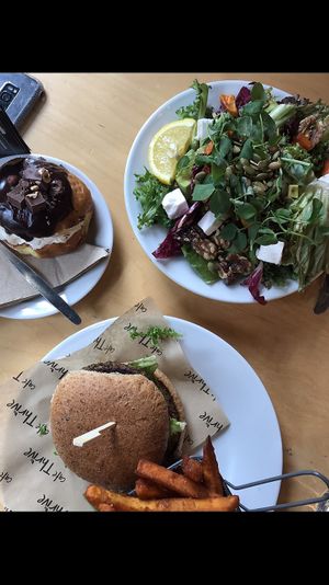 Lentil burger with sweet potato chips, beetroot, walnut and “feta” salad and cream filled donut at Cafe Thrive in Southampton