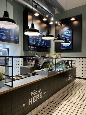 Order and pick up counter with menu on digital display at Swing Kitchen - Kaiserfeldgasse in Graz